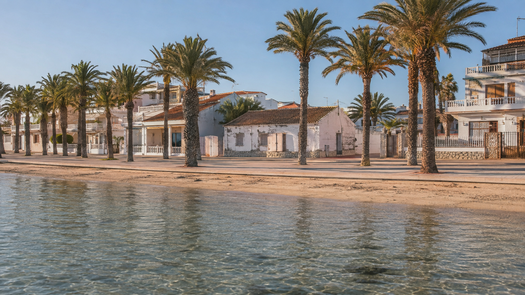 Paseo marítimo del Mar Menor al atardecer, con edificaciones bajas frente al agua